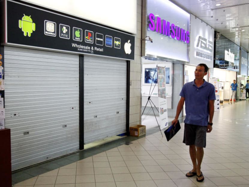 A man walks past a shop with its shutters closed in Sim Lim Square. Unethical business tactics like those of some traders at Sim Lim Square have caused consumers to be more cautious, CASE said. TODAY file photo