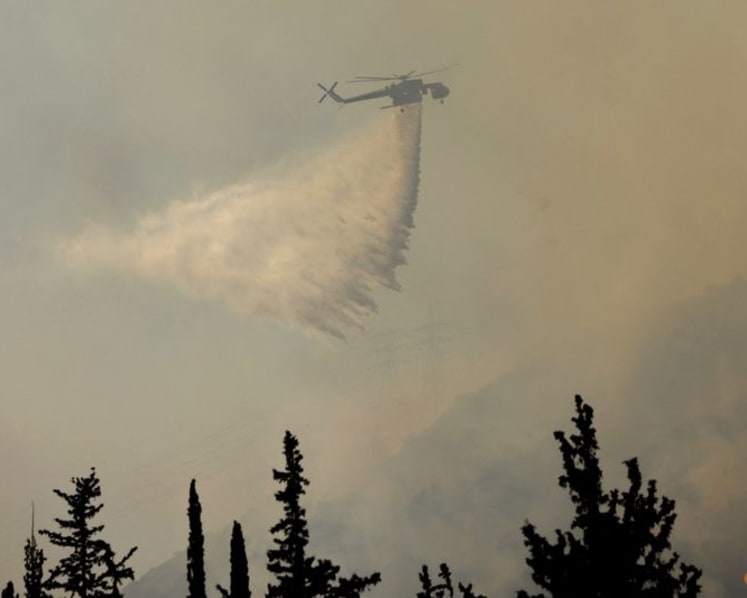 Firefighters in Greece struggle to save coastal resort as winds rage