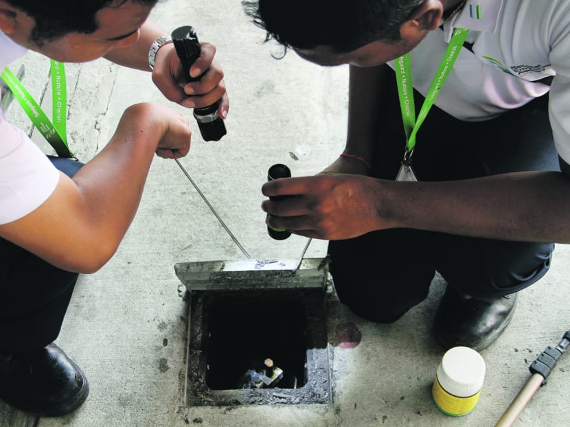 NEA officers conducting dengue checks. TODAY file photo