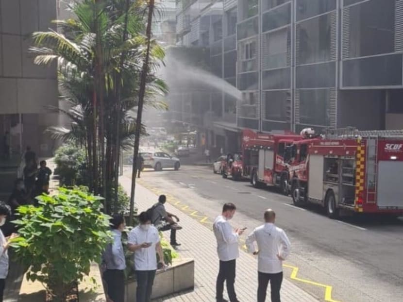 People are seen waiting on the pavement next to Shaw Centre on Nov 22, 2021.