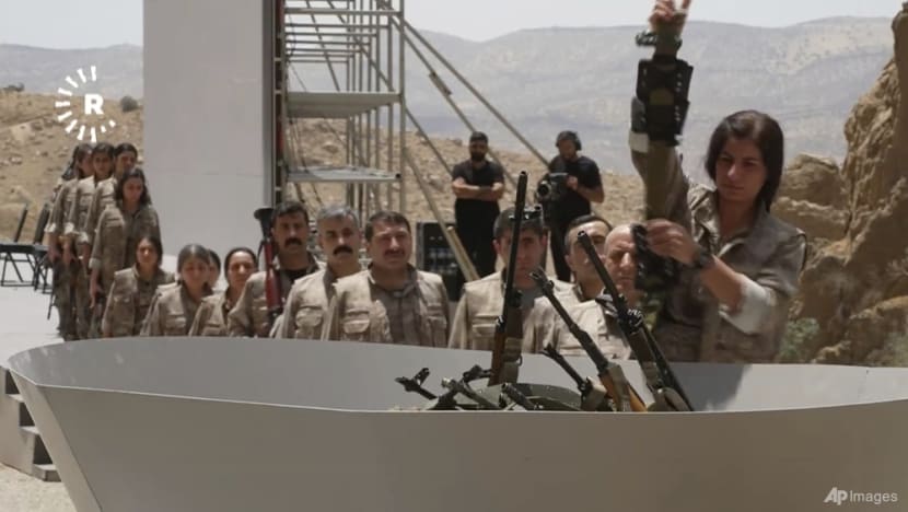 Kurdish PKK militants burn weapons in Iraq to launch disarmament