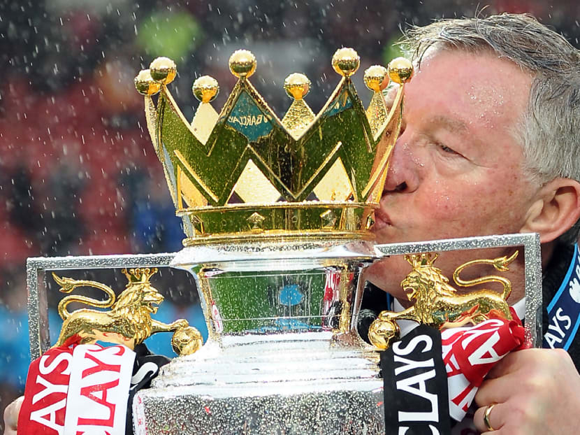 Sir Alex Ferguson kisses the Premier League trophy at the end of the English Premier League football match between Manchester United and Swansea City at Old Trafford in Manchester, northwest England, on May 12, 2013. AFP file photo