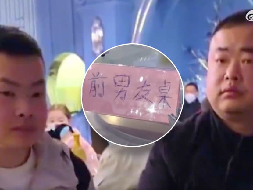 A sign (centre) showing the words "table for ex-boyfriends" at a wedding banquet in Hubei, China. A sign (centre) showing the words "table for ex-boyfriends" at a wedding banquet in Hubei, China.
