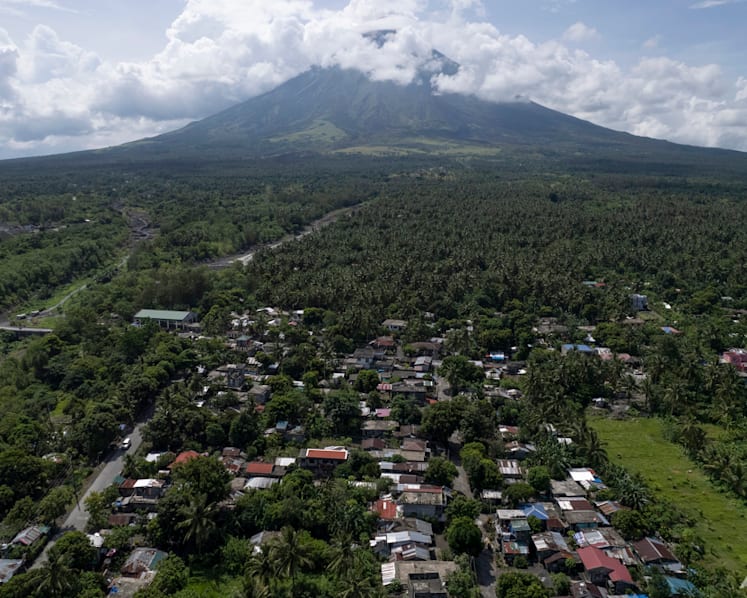 Poor villagers risk their lives in danger zone as Philippines' most active volcano erupts