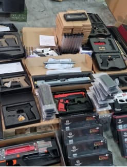 The shipment of 20 replica guns and 54 magazines seized by the authorities.  