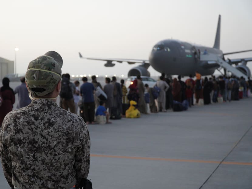A Singapore Army personnel on duty as evacuees board the Republic of Singapore Air Force's A330 MRTT at Al Udeid Air Base in Qatar.