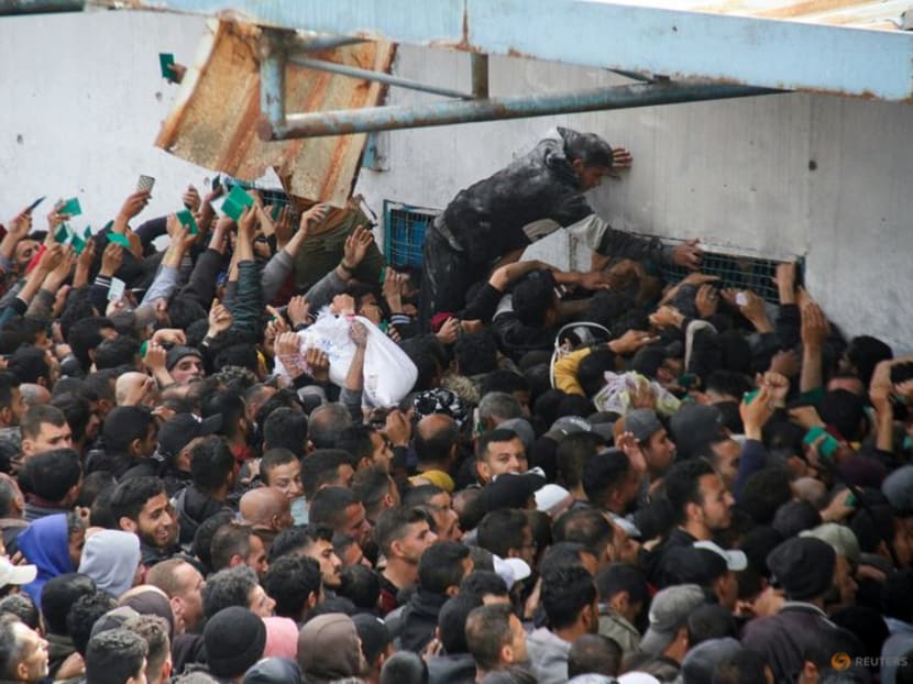 Palestinians gather to receive aid in Gaza City.