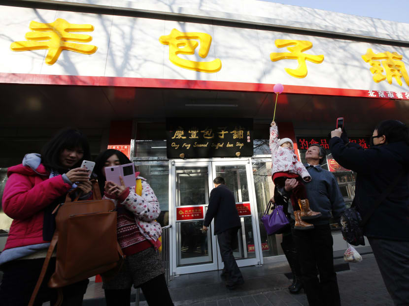 Visitors taking pictures for remembrance at the Qingfeng steamed buns restaurant in Beijing, where Chinese President Xi Jinping visited and dined at in 2013.