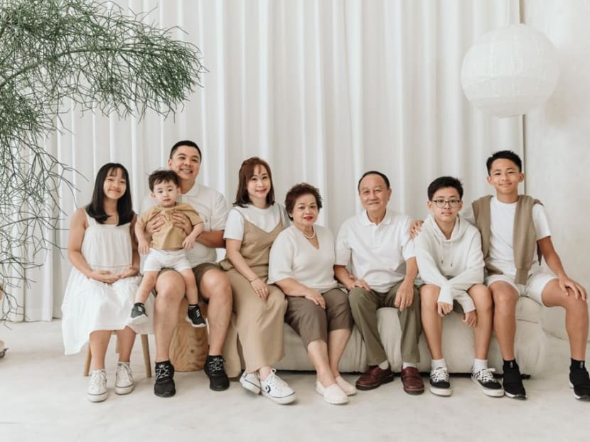 Mrs Celine Ng (fifth from right) with her family in a photo taken in a studio.