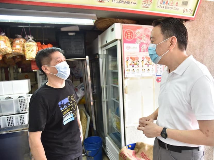 Mr Melvin Yong (right), Member of Parliament for Radin Mas, talking to a stallholder at Redhill Market and Food Centre.