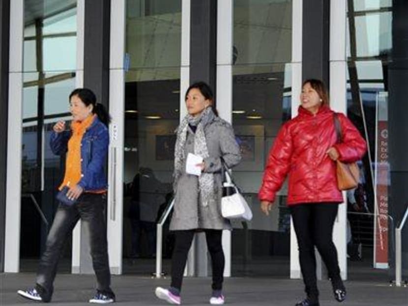 People walk by the venue of the 20th International AIDS Conference in Melbourne. Australia, Friday, July 18, 2014. Photo: AP
