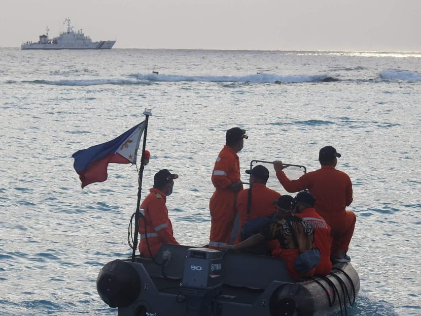 In this undated handout photo received from the Philippine Coast Guard on April 25, 2021, coast guard personnel conduct maritime exercise near Thitu island in the disputed South China Sea. In this undated handout photo received from the Philippine Coast Guard on April 25, 2021, coast guard personnel conduct maritime exercise near Thitu island in the disputed South China Sea.