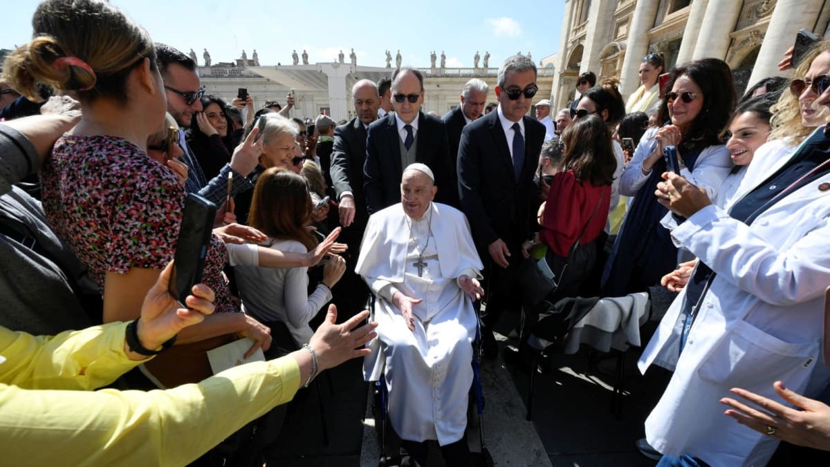 Pope Francis greets crowds at Vatican in first appearance since leaving hospital