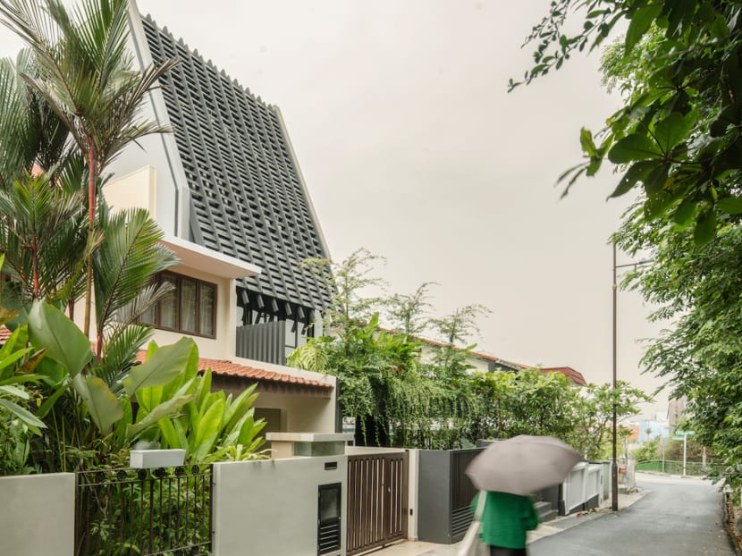 This house in Singapore has an unusual, slanted roof and facade