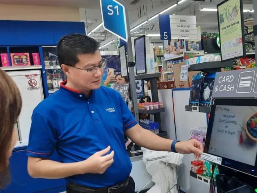 An NTUC FairPrice employee showing the barcode which customers at self-checkout counters will have to scan to pay for each plastic bag they take. An NTUC FairPrice employee showing the barcode which customers at self-checkout counters will have to scan to pay for each plastic bag they take.