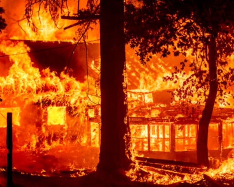 California's largest fire burns homes as blazes scorch West