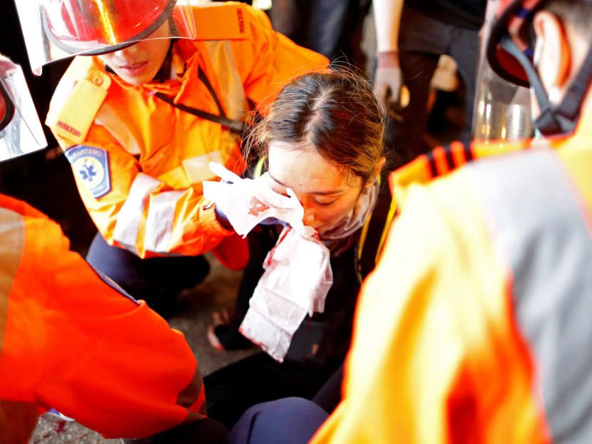 An injured woman receives medical assistance after being hit in her right eye during a demonstration in Tsim Sha Tsui neighbourhood in Hong Kong, China, Aug 11, 2019. An injured woman receives medical assistance after being hit in her right eye during a demonstration in Tsim Sha Tsui neighbourhood in Hong Kong, China, Aug 11, 2019.