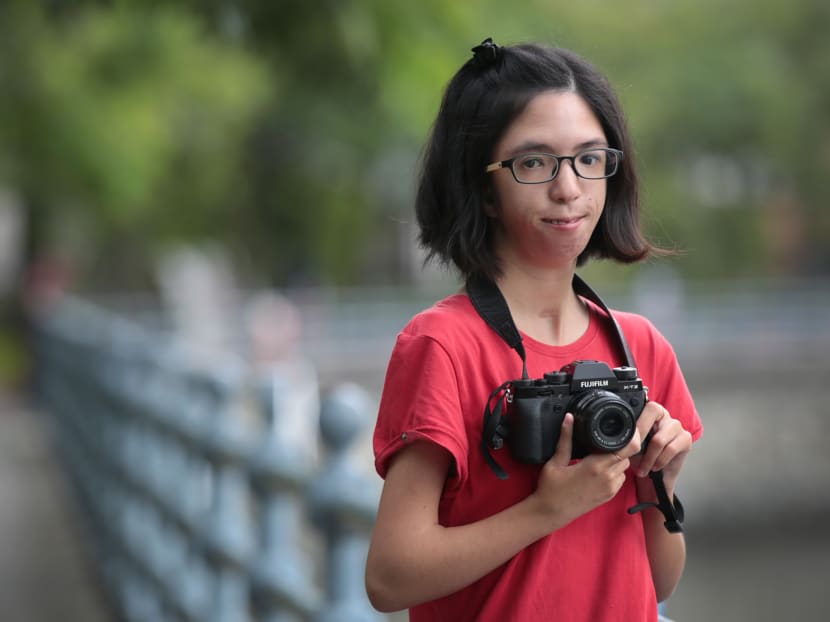 Born with an extremely rare condition that affects the development of her face, hands and arms, as well as hearing, 23-year-old Isabelle Lim wants to steer the public attention to something else now: Her professional career as a photographer. Photo: Jason Quah/TODAY