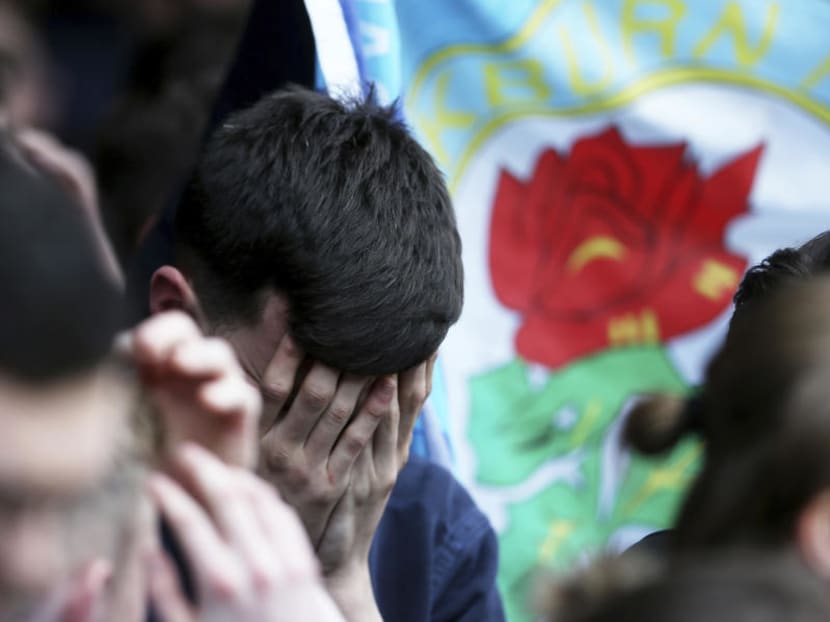 Blackburn Rovers fans shed tears after the final whistle during their English Championship soccer match against Brentford on Sunday. Blackburn’s slide down the English soccer league plunged further when the former Premier League champion was relegated to the third tier, intensifying the club’s woes under its Indian owners. Photo: AP