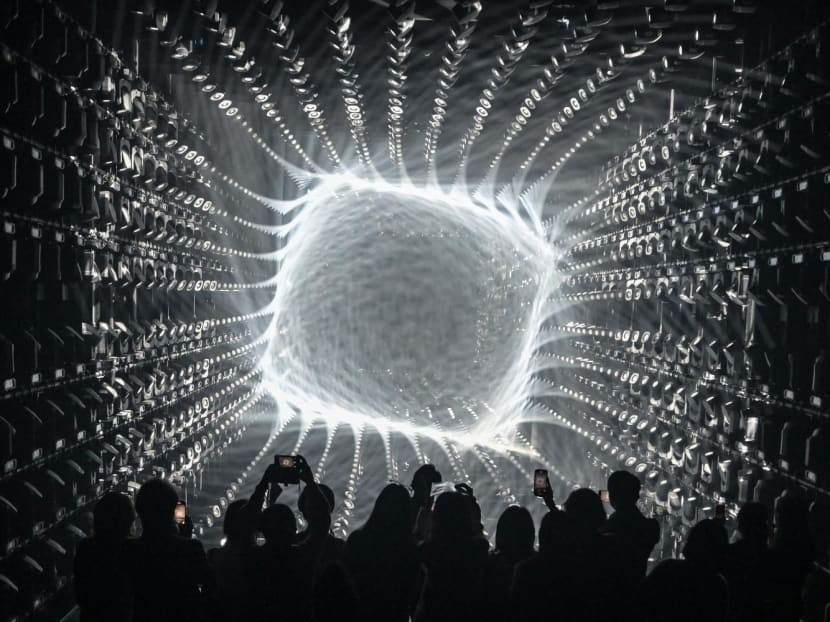 Visitors watch a light display during a tour of the new location for the digital art of Japanese collective "teamLab" at the recently opened 325m Azabudai Hills tower in Tokyo. Visitors watch a light display during a tour of the new location for the digital art of Japanese collective "teamLab" at the recently opened 325m Azabudai Hills tower in Tokyo.