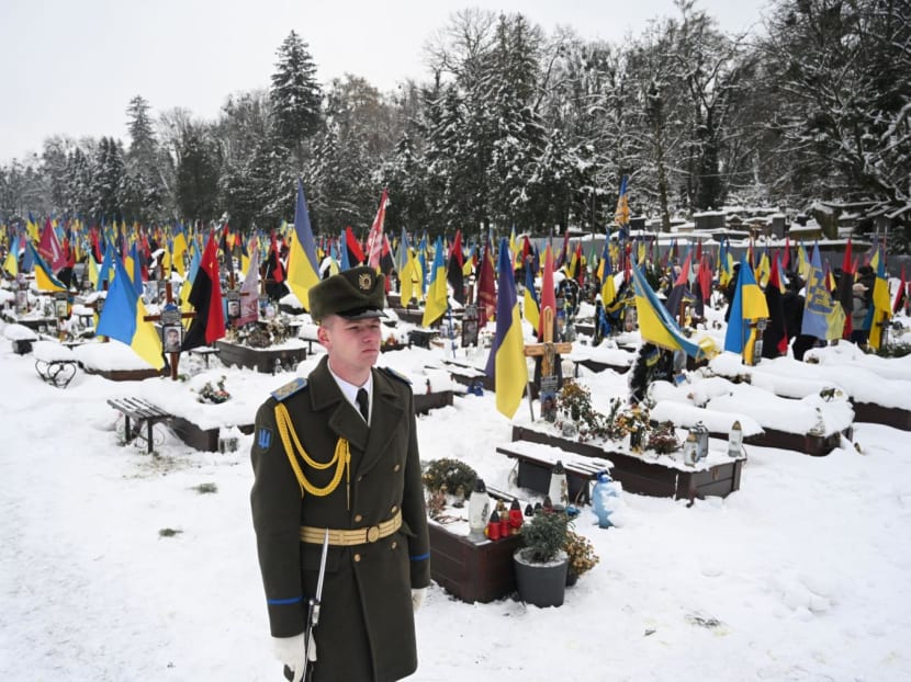 An honour guard stands next to the graves of Ukrainian soldiers on the Day of the Armed Forces of Ukraine at Lychakiv cemetery in the western Ukrainian city of Lviv on Dec 6, 2023, amid the Russian invasion of Ukraine. An honour guard stands next to the graves of Ukrainian soldiers on the Day of the Armed Forces of Ukraine at Lychakiv cemetery in the western Ukrainian city of Lviv on Dec 6, 2023, amid the Russian invasion of Ukraine.