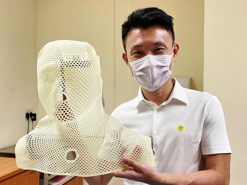 Member of Parliament Baey Yam Keng with a shell he wears during radiation therapy sessions at Singapore General Hospital.