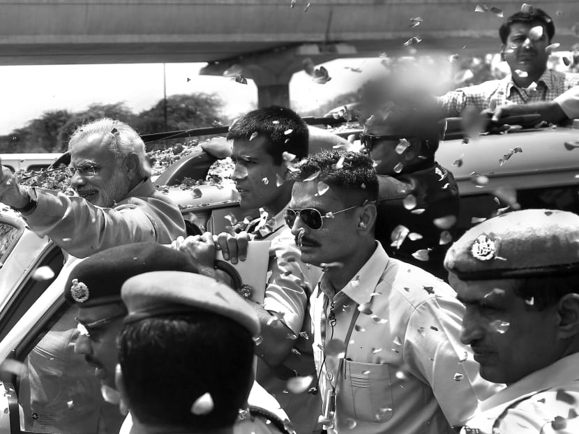 Prime-Minister-designate Narendra Modi from the Bharatiya Janata Party (BJP), acknowledging his supporters during a road show in Delhi a day after the results of the elections were announced. BJP and its allies won 336 seats out of 543 in the Lower House of Parliament. Photo: REUTERS