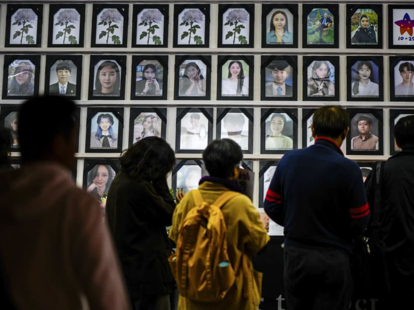 People pay their respects in a marquee filled with photos of victims as they attend a vigil in Seoul on Oct 29, 2023, to mark the first anniversary of the tragic crowd crush that killed 159 people during Halloween celebrations, in Seoul’s popular Itaewon nightlife area a year ago.