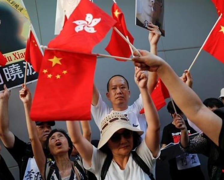 Commentary: 20 years later, Hong Kong an embattled one city, two people