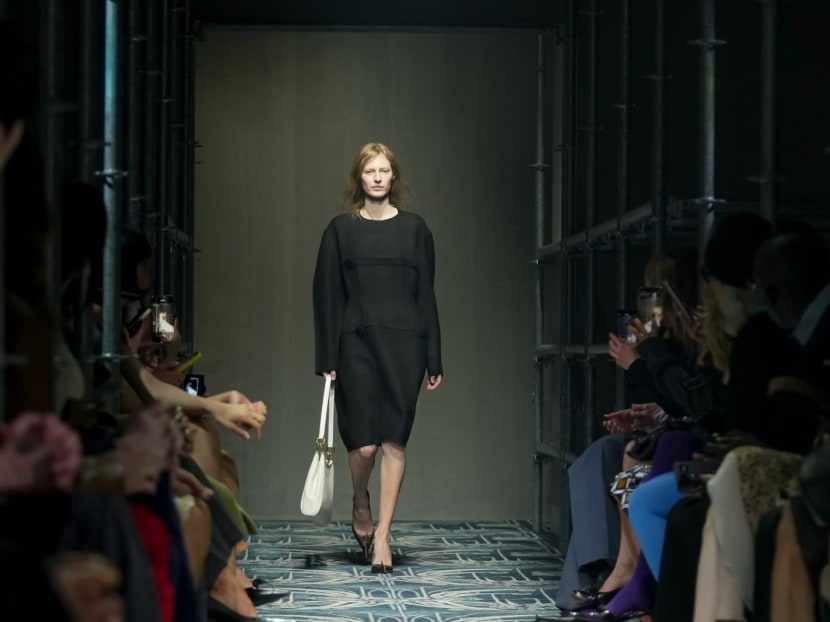 Prada reconstructs femininity starting with the little black dress fit to dark times