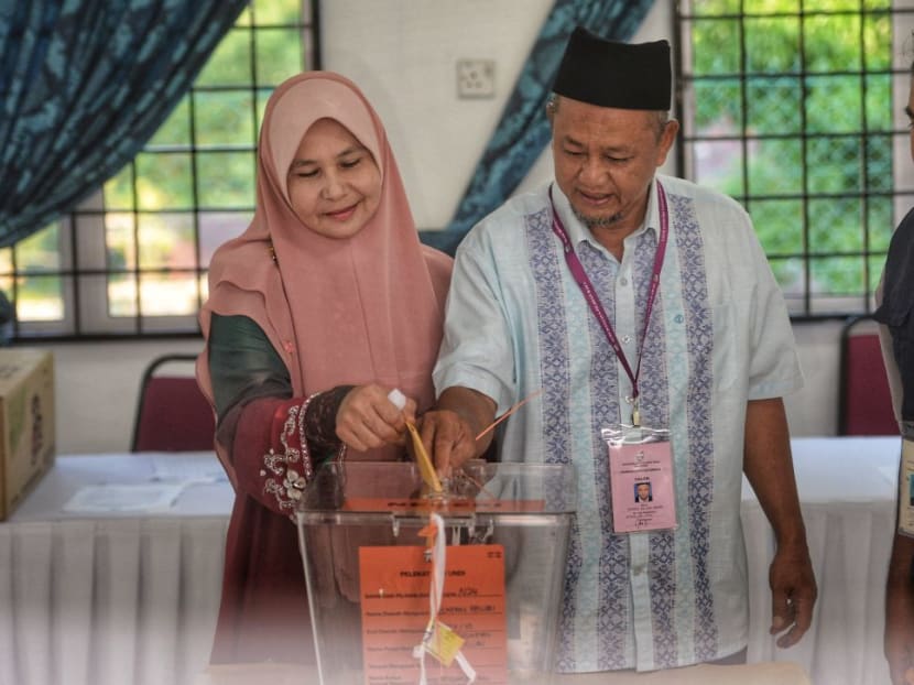 BN candidate Zakaria Hanafi and his wife, Ms Katijah Beebi Bayikhan cast their vote for the by-election. BN candidate Zakaria Hanafi and his wife, Ms Katijah Beebi Bayikhan cast their vote for the by-election.