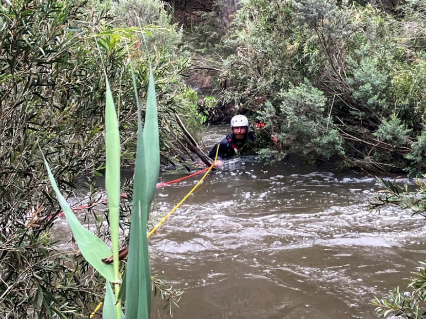 This handout photo taken and released by the Victoria Police on December 27, 2023 shows an emergency worker during a rescue operation in the midst of flood waters after heavy rain at the Buchan campground in east Gippsland, located east of Melbourne in the Australian state of Victoria. Rescue crews were searching on December 27 for survivors after seven people died in heavy storms across Australia's eastern seaboard, including a 40-year-old woman sucked into a stormwater drain.