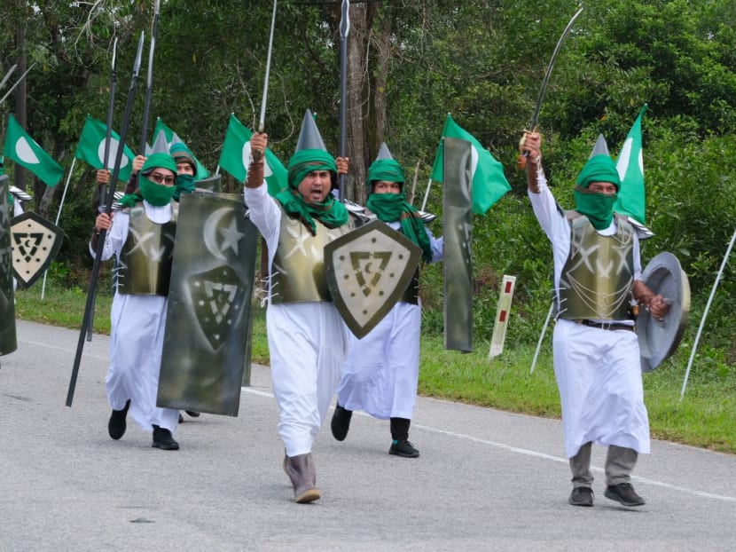 Islamic party in Malaysia under probe after members stage march with fake swords, spears and shields