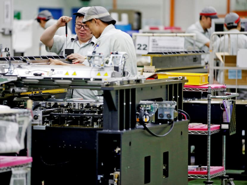 Employees at a printed circuit board assembly factory in Singapore. Economists said there are ‘signs of moderation’ in the electronics manufacturing sector. Photo: Reuters