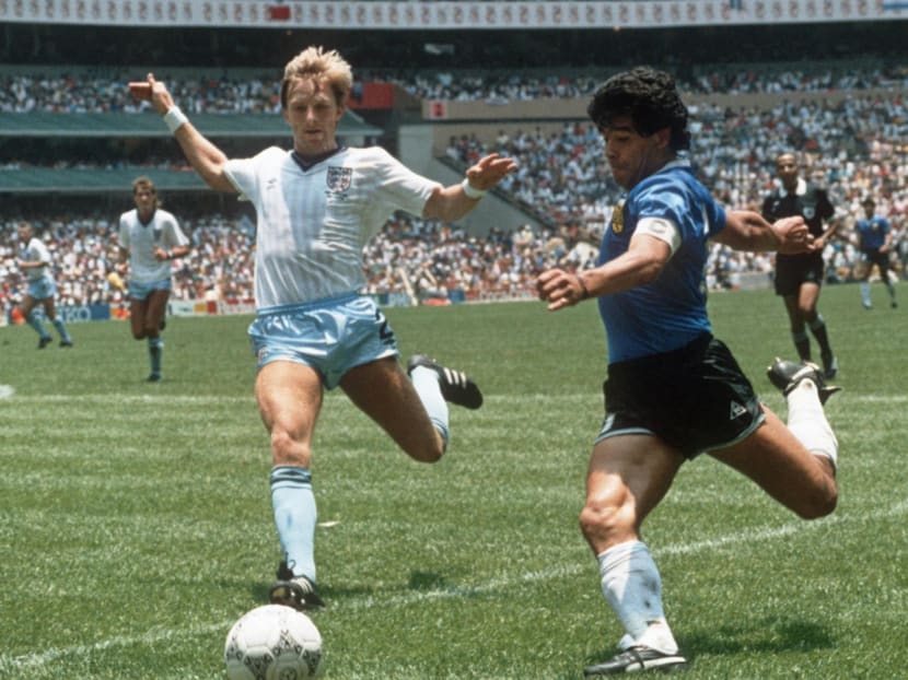 Diego Maradona gets ready to cross the ball under pressure from English defender Gary Stevens during the World Cup quarterfinal soccer match between Argentina and England on 22 June 1986 in Mexico City. Argentina beat England 2-1 on goals by Maradona.