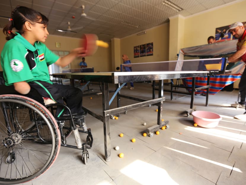 Twelve-year-old disabled Iraqi Nejla Imad plays table tennis in Baquba, a city northeast of Baghdad, on Feb 20, 2016. Photo: AFP