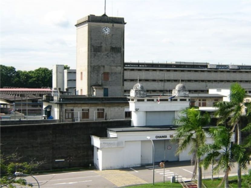 While in remand at Changi Prison, Mohamad Farhan Tajuddin wandered out of his cell to chat with his neighbour while another person was brought to his cell. Photo: Singapore Prison Service