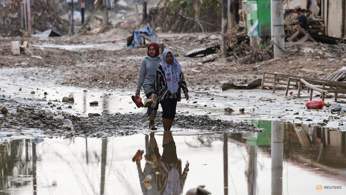Survivors pick up pieces in flood-hit Indonesia as more rain predicted