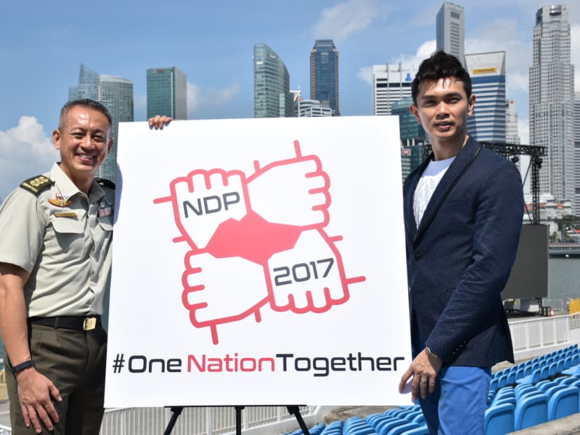 L-R: Colonel Melvin Ong, Chairman of NDP 2017 Executive Committee and Jay Lim, singer of this year's NDP theme song "Because It's Singapore!" posing with the NDP 2017 logo. Photo:Esther Leong/TODAY L-R: Colonel Melvin Ong, Chairman of NDP 2017 Executive Committee and Jay Lim, singer of this year's NDP theme song "Because It's Singapore!" posing with the NDP 2017 logo. Photo:Esther Leong/TODAY