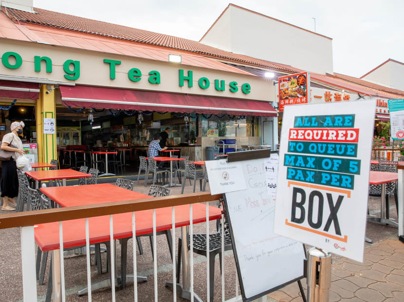 A sign reminding diners that only five people per table are allowed at Enak Enak Hong Kong Tea House at East Coast Seafood Centre on May 9, 2021.