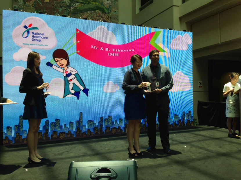 Mr S B Viknesan, senior counsellor from the Institute of Mental Health, receiving his award.