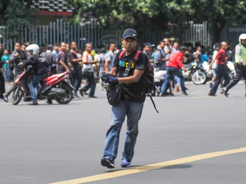 Seven dead in Jakarta blasts, gunfight