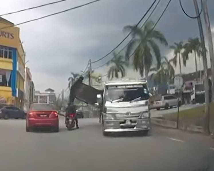 Motorcyclist injured by burger stall falling from moving lorry in Malaysia