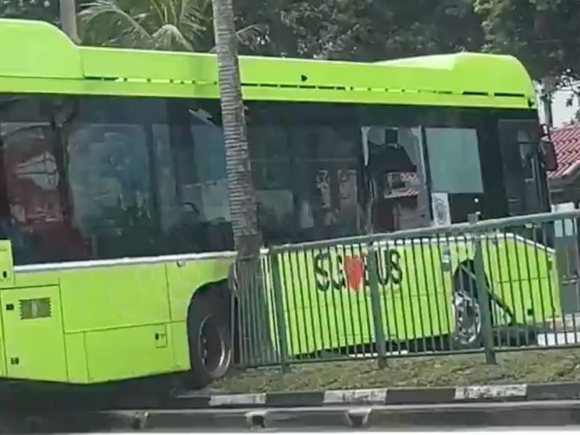 Screengrab from social media showing a bus mounted on a road divider after crashing into it on Oct 12, 2022. Screengrab from social media showing a bus mounted on a road divider after crashing into it on Oct 12, 2022.