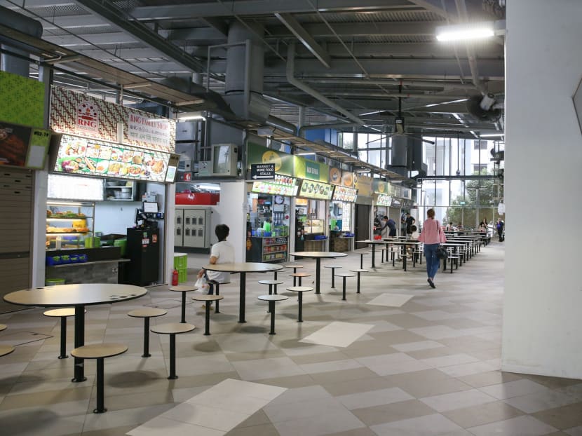 The author, seen here on the right during a recent visit to Jurong West Hawker Centre, says that Singaporeans want our hawker food cheap and good, but have no qualms about paying a premium for cafe food and Starbucks drinks.