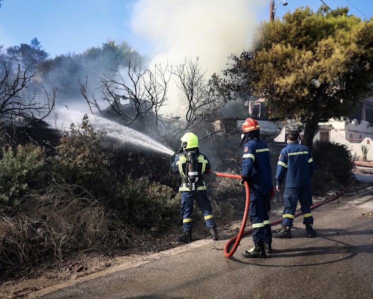 Two dead, hundreds evacuated from fires on island near Athens