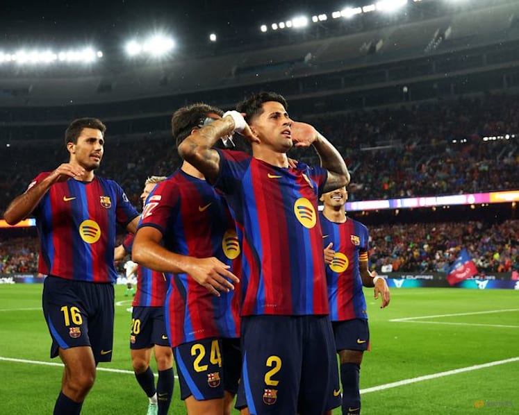 Flick sets record as Barcelona breeze past Racing with Raphinha hat-trick