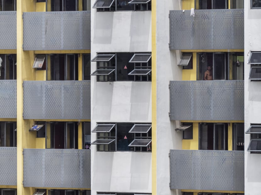A migrant worker stands by a window at Westlite Mandai dormitory, in a picture taken on April 28, 2020.