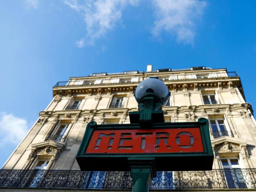 A metro sign is seen in a street in Paris.