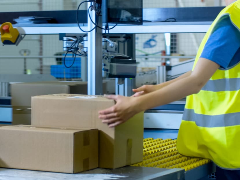 A general view of a postal worker sorting parcels. Singapore Post said that its two full-time employees who contracted Covid-19 are not postmen and do not have contact with members of the public in their line of work.